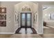 Grand foyer featuring high ceilings, chandelier, and decorative glass double doors at 7469 Seacroft Cv, Lakewood Ranch, FL 34202