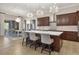 This kitchen features a center island with seating, modern pendant lights, and an open floorplan at 7469 Seacroft Cv, Lakewood Ranch, FL 34202