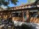 Back exterior view featuring covered seating area, and lush landscaping at 7523 4Th W Ave # 7523, Bradenton, FL 34209