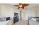 Cozy bedroom featuring a unique leaf-shaped ceiling fan and ample closet space at 7523 4Th W Ave # 7523, Bradenton, FL 34209