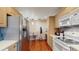 Kitchen with stainless steel refrigerator, eat-in counter, and wood floors at 7523 4Th W Ave # 7523, Bradenton, FL 34209