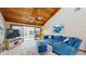 Bright living room with vaulted wood ceiling, sliding glass doors, and comfortable seating at 7523 4Th W Ave # 7523, Bradenton, FL 34209