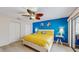 Main bedroom with a blue accent wall, access to the patio, and double closets at 7523 4Th W Ave # 7523, Bradenton, FL 34209