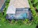 Aerial view of a private screened-in pool, patio with blue furniture, lush landscaping, and well-maintained roof at 813 Tailwind Pl, Sarasota, FL 34240