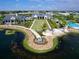 Aerial view of community featuring lake, pool, landscaping, and various residences at 813 Tailwind Pl, Sarasota, FL 34240