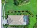 Top-down aerial view of a home showcasing a pool, meticulous landscaping, an adjacent side street, and a sidewalk at 813 Tailwind Pl, Sarasota, FL 34240