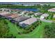 Beautiful home overlooking a scenic lake, surrounded by lush greenery, creating a serene atmosphere at 813 Tailwind Pl, Sarasota, FL 34240