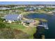 Aerial view showcasing a lakeside community with modern homes, landscaping, and water features at 813 Tailwind Pl, Sarasota, FL 34240