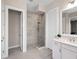 Contemporary bathroom featuring a glass enclosed shower and white vanity with countertop at 813 Tailwind Pl, Sarasota, FL 34240