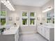 Bright bathroom with dual sinks, white cabinetry, and natural light at 813 Tailwind Pl, Sarasota, FL 34240