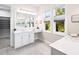 Bright bathroom with double vanity, quartz countertop and dual windows offering natural light at 813 Tailwind Pl, Sarasota, FL 34240