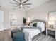 A stylish bedroom with a king bed, ceiling fan, and en-suite bathroom access at 813 Tailwind Pl, Sarasota, FL 34240
