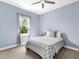 Light blue bedroom with ceiling fan, window view, and comfortable decor, creating a serene atmosphere at 813 Tailwind Pl, Sarasota, FL 34240