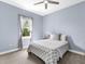 Neutral colored bedroom with a gray and white patterned bedspread at 813 Tailwind Pl, Sarasota, FL 34240