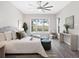 A serene bedroom featuring neutral tones, a large window, and a ceiling fan at 813 Tailwind Pl, Sarasota, FL 34240