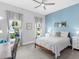 Cozy bedroom features a blue accent wall, natural light and comfortable decor at 813 Tailwind Pl, Sarasota, FL 34240