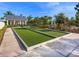 Community bocce ball court and lush landscaping under a sunny, blue sky at 813 Tailwind Pl, Sarasota, FL 34240