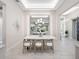 Bright dining area featuring a modern chandelier, a large mirror, and stylish decor at 813 Tailwind Pl, Sarasota, FL 34240