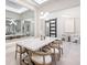 Elegant dining room features a modern table, stylish chandelier, and a large mirror reflecting the bright interior at 813 Tailwind Pl, Sarasota, FL 34240