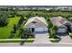 Charming single-story home featuring a paved driveway, three-car garage, and well-manicured landscaping at 813 Tailwind Pl, Sarasota, FL 34240