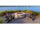 Outdoor fire pit with comfortable seating, perfect for relaxing and enjoying the scenery at 813 Tailwind Pl, Sarasota, FL 34240