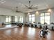 Bright fitness center with wood floors, fans, mirrors, and an array of exercise equipment at 813 Tailwind Pl, Sarasota, FL 34240