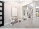 Spacious foyer with high ceilings, recessed lighting, and modern decor, including two chairs and artwork at 813 Tailwind Pl, Sarasota, FL 34240