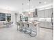 Modern kitchen with an island, barstool seating, and stainless steel appliances at 813 Tailwind Pl, Sarasota, FL 34240