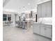 Open-concept kitchen and dining area showcases stylish gray cabinets and modern pendant lighting at 813 Tailwind Pl, Sarasota, FL 34240