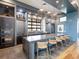 Modern kitchen featuring stainless steel appliances, a large island with seating, and stylish pendant lighting at 813 Tailwind Pl, Sarasota, FL 34240