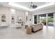 The living room features built-in shelves and a large sliding door to the outdoor lanai at 813 Tailwind Pl, Sarasota, FL 34240