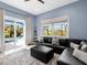 Comfortable living room with a plush sectional sofa and sliding doors to the pool at 813 Tailwind Pl, Sarasota, FL 34240