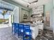 Outdoor kitchen and bar area with modern appliances and countertop, set within a covered patio at 813 Tailwind Pl, Sarasota, FL 34240
