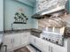 Outdoor kitchen with granite countertops, stainless steel grill and custom backsplash at 813 Tailwind Pl, Sarasota, FL 34240