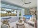 Cozy outdoor living area with a seating area and a summer kitchen with a view of the pool at 813 Tailwind Pl, Sarasota, FL 34240