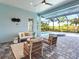 Covered patio area with stylish outdoor furniture overlooks a sparkling pool and spa at 813 Tailwind Pl, Sarasota, FL 34240