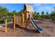 Community playground with slide, climbing structure, and swings for outdoor fun at 813 Tailwind Pl, Sarasota, FL 34240