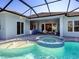 Backyard pool and spa area with a screened enclosure, perfect for outdoor entertaining at 813 Tailwind Pl, Sarasota, FL 34240