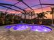 Relax in this private, screened-in pool and spa area, surrounded by lush tropical landscaping at 813 Tailwind Pl, Sarasota, FL 34240