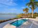 Community hot tub overlooking lake, palm trees, and neighborhood at 813 Tailwind Pl, Sarasota, FL 34240
