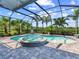 Screened-in pool area with a spa, lush greenery, and a tranquil outdoor space at 813 Tailwind Pl, Sarasota, FL 34240