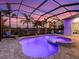 Inviting screened-in pool with spa, patio area, and ambient lighting, perfect for relaxation and entertainment at 813 Tailwind Pl, Sarasota, FL 34240