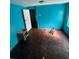 This spacious bedroom features bright blue walls and original hardwood floors, with room for customization at 815 30Th W Dr, Bradenton, FL 34205