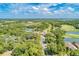 Aerial view highlighting the golf course and community buildings surrounded by green spaces and mature trees at 8782 49Th E Ter, Bradenton, FL 34211