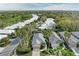An aerial view shows homes in a vibrant community featuring mature trees, lush landscaping, and well-maintained streets at 8782 49Th E Ter, Bradenton, FL 34211