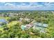 Scenic aerial shot of the golf course, community center, and pool surrounded by lush landscaping and blue skies at 8782 49Th E Ter, Bradenton, FL 34211