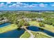 Bird's-eye view showcases the golf course and surrounding community with picturesque water features and lush greenery at 8782 49Th E Ter, Bradenton, FL 34211