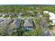 Aerial view shows the home's screened-in pool area and lush green surroundings at 8782 49Th E Ter, Bradenton, FL 34211