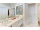 Bright bathroom featuring dual sinks, a frameless shower, neutral tile and large mirrors at 8782 49Th E Ter, Bradenton, FL 34211