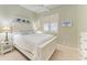 Comfortable bedroom featuring a white bed frame, coastal decor and natural light from the shuttered window at 8782 49Th E Ter, Bradenton, FL 34211